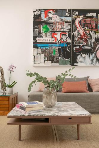 a coffee table in a living room with a couch at The Luxury Inn in London