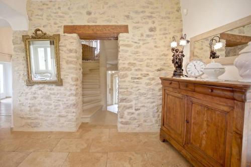 sala de estar con espejo y armario de madera en Authentique propriété, en Bonnieux