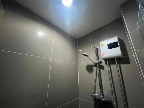 a bathroom with a soap dispenser on a wall at 1 bedroom Centrio Condominium Phuket Near Central Foresta Cental Festival in Ban Rangeng