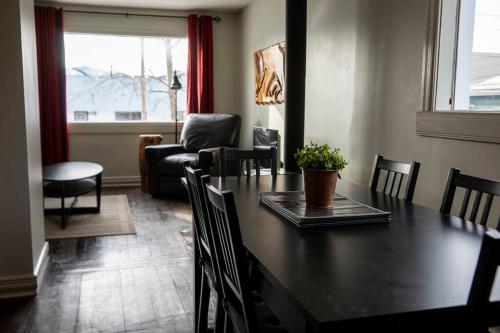 a dining room with a table and chairs and a couch at The Cozy Red Cabin in Bellevue