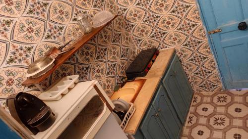 a bathroom with a sink and a toilet on a wall at L'Oasis à Tozeur in Tozeur