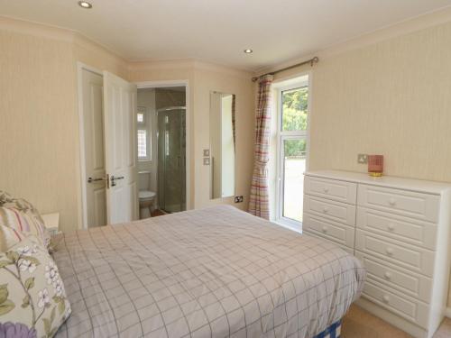 1 dormitorio con 1 cama, vestidor y ventana en Teesdale Lodge, en Yarm