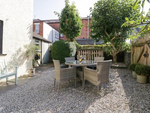 a patio with a table and chairs in a yard at Heatherlea in Keswick