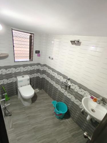 a bathroom with a toilet and a sink at Bethel Villa in Vaishet
