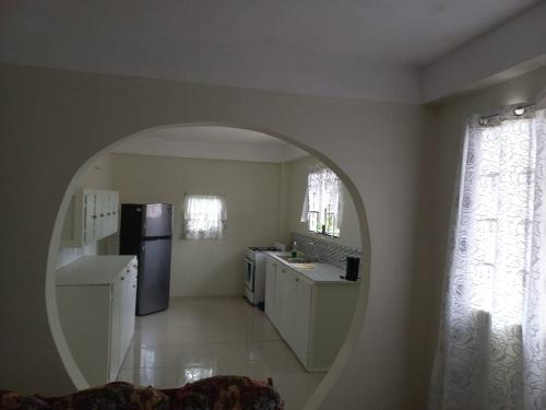 a kitchen with an oval mirror in a room at Cocrico Apartments in Scarborough