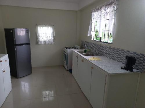 a kitchen with a refrigerator and a stove in it at Cocrico Apartments in Scarborough