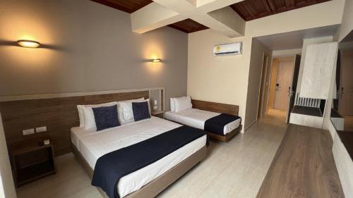 a hotel room with two beds and a window at On Vacation Caribbean in San Andrés