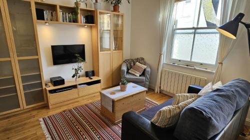 a living room with a couch and a tv at Number 1 in Saint Mawes