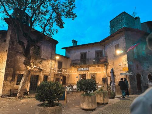an old building with people walking in front of it at House Scanno centro storico in Scanno