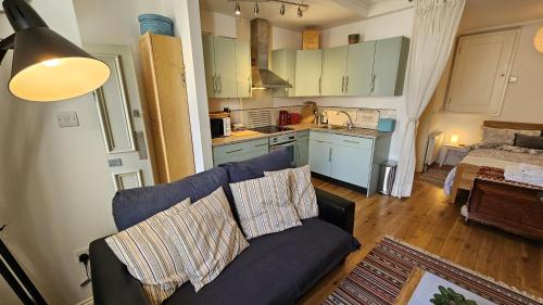 a living room with a couch and a kitchen at Number 1 in Saint Mawes