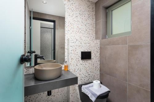 a bathroom with a bowl sink and a mirror at Villa Michalis in Xirón Khoríon