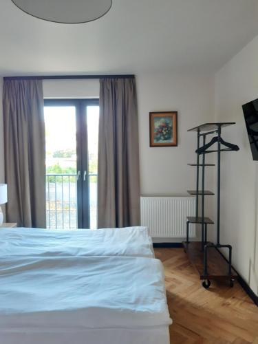 a bedroom with a bed and a window at Arte Gdańsk in Gdańsk