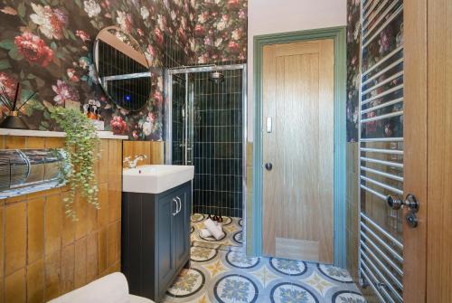 uma casa de banho com um lavatório e um gato deitado no chão em The Rose Nobel - 1 Bed Studio Apartment in Bristol by Mint Stays em Bristol