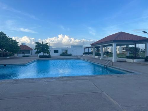 a large swimming pool with a gazebo at Large Luxurious Beach Front 1 Bedroom at Bayfront Villa in Portmore