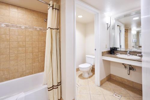 a bathroom with a tub and a toilet and a sink at Sunset Station Hotel & Casino in Las Vegas