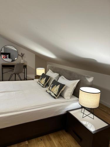 a bedroom with a bed with pillows and a table at Sana Ski apartment 702 in Flora, Borovets in Borovets