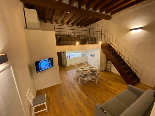an overhead view of a living room with a couch and a tv at signoria flat 5* centro storico in Florence