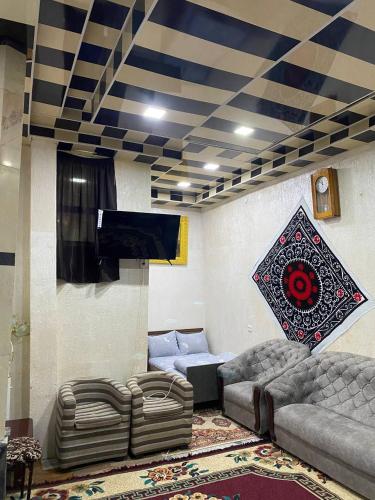 a living room with a couch and couches in a room at HOSTEL NABI BOBO in Samarkand