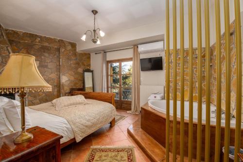 Кровать или кровати в номере Archontiko Fiamegou Hotel&Spa