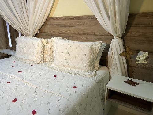 a bedroom with a bed with red flowers on it at Pedra do Sino Hotel in Piranhas