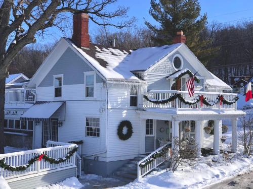 a white house with christmas wreaths on it at The French Country Inn in Lake Geneva