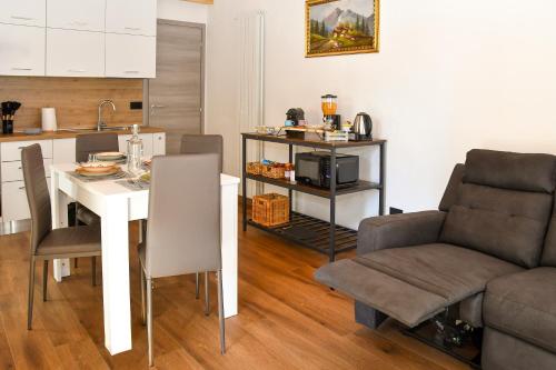 a kitchen and dining room with a table and chairs at La Terrazza in Malesco