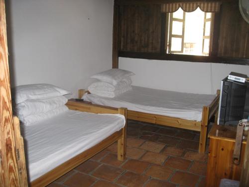 Postel nebo postele na pokoji v ubytování Nanjing Tulou Qingdelou Inn