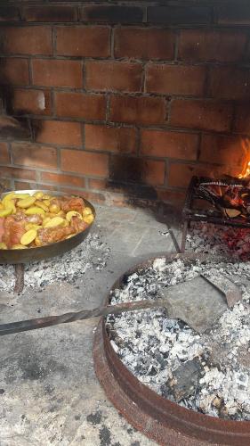 a pizza is cooking in a brick oven at Rustic Lodge Plitvice in Plitvička Jezera