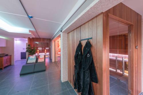 a black jacket hanging on a wall in a room at Hof van In & Wellness in Hasselt