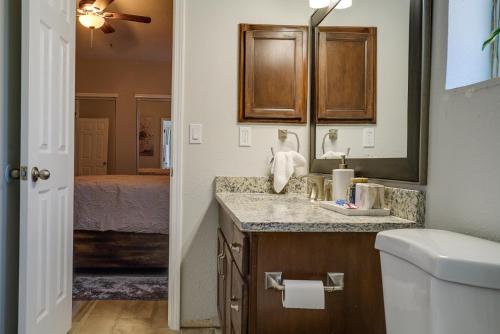 a bathroom with a sink and a mirror and a bed at Pet-Friendly El Paso Retreat 20 Mi to Downtown! in El Paso