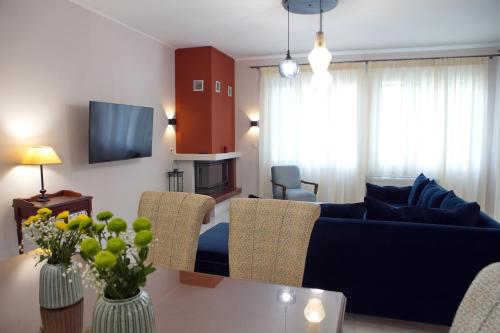 a living room with a couch and a table at AKAKIA VILLA NAFPLIO in Nafplio