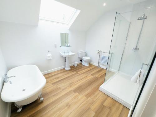 a bathroom with a sink and a toilet and a shower at Blossom Holiday Lets - 96 Roseberry Cottages in Guisborough