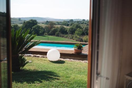 a view of a swimming pool from a window at Agriturismo Podere Ristella - Wine&Food in Montemassi