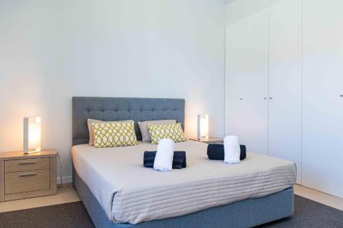una camera da letto con un letto con due lampade sopra di Mosteiros Beach House a Mosteiros