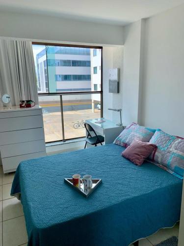 a bedroom with a bed with a tray of food on it at Kit completa - Parque Norte in Brasilia