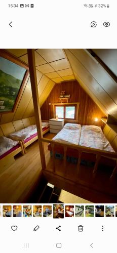 a small attic room with two beds in it at Chalúpka Sokolí dvor s wellnesom in Terchová