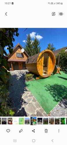 a picture of a house with a boat on a lawn at Chalúpka Sokolí dvor s wellnesom in Terchová