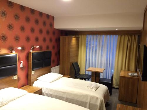 Een bed of bedden in een kamer bij Bayraktar Hotel