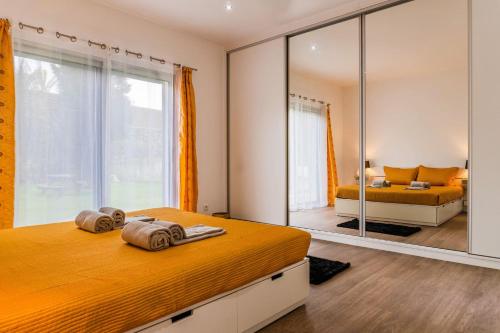 a bedroom with a bed and a mirror at Santana Beach House in Ribeira Grande