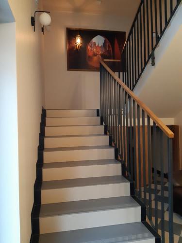 a staircase with grey and white steps and a painting at Arte Gdańsk in Gdańsk