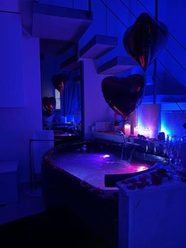 a dark room with a hot tub with purple lights at Affittacamere La Magnolia in Bacoli