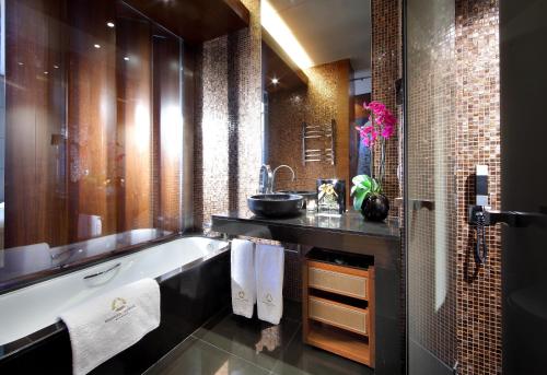 a bathroom with a bath tub and a sink at Eurostars Madrid Tower in Madrid