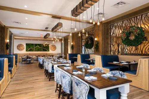 a dining room with tables and blue chairs at Dollywood's HeartSong Lodge & Resort in Pigeon Forge