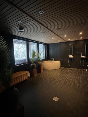 a large bathroom with a bath tub and a sink at Grand Hideout Levi in Kittilä