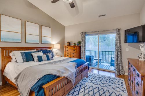 a bedroom with a bed and a balcony at Camdenton Condo with Patio, Pool and Lake Access! in Camdenton