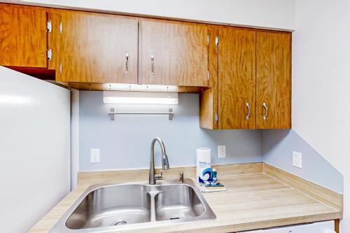a kitchen with a sink and wooden cabinets at Canal Carnival in Sebring