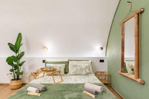 a bedroom with a bed and a table and a mirror at Varriale house ecogreen in Naples