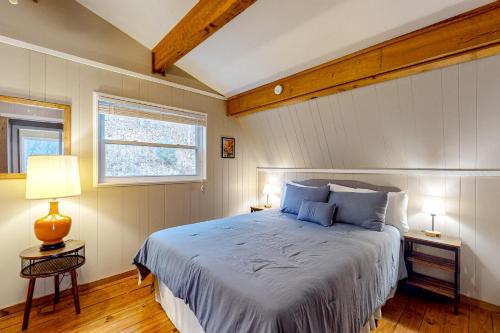 a bedroom with a large bed and a window at Bryson Chalet in Bryson City