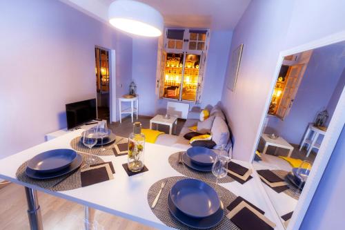 a kitchen and living room with a table and chairs at Appartement d'une chambre avec vue sur la ville terrasse et wifi a Charleville Mezieres a 4 km de la plage in Charleville-Mézières