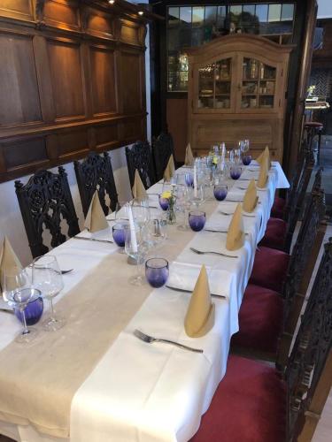 a long table with plates and napkins on it at Hotel zur Brücke in Herzogenrath